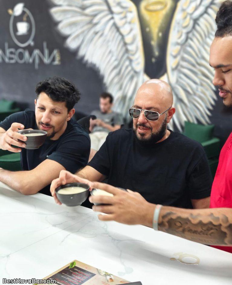 Friends sharing bowls of kava at a bar counter